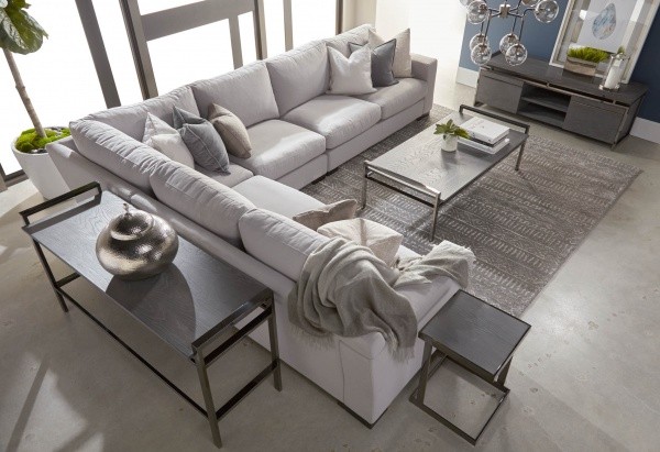luxury living room featuring grey wraparound sofa with black wood furniture with grey area rug