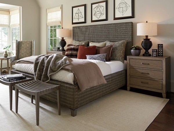 luxury home furniture master bedroom with multicolored bedding, brown wood furniture and grey wicker bed frame