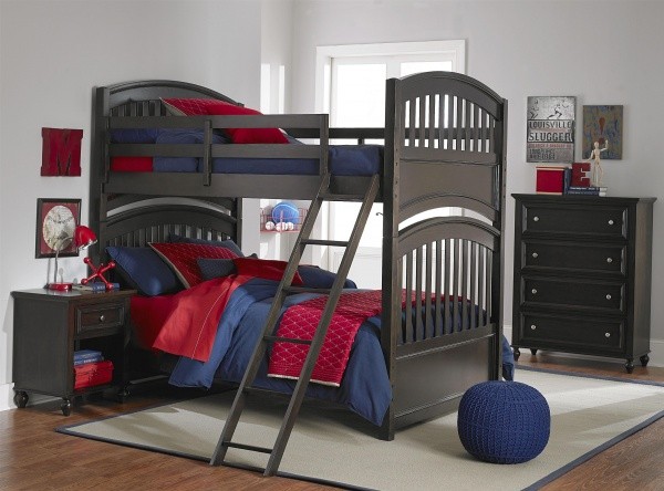 luxury finished interior secondary bedroom with wooden bunk beds with red and blue sheets and dark wood furniture