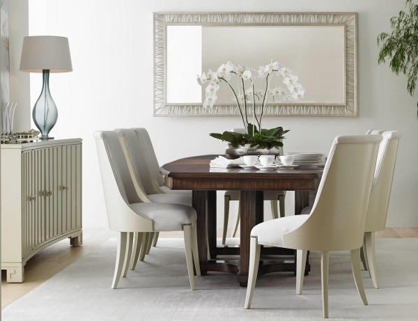 luxury dining room with wooden dining room table with eight white chairs and white cabinets