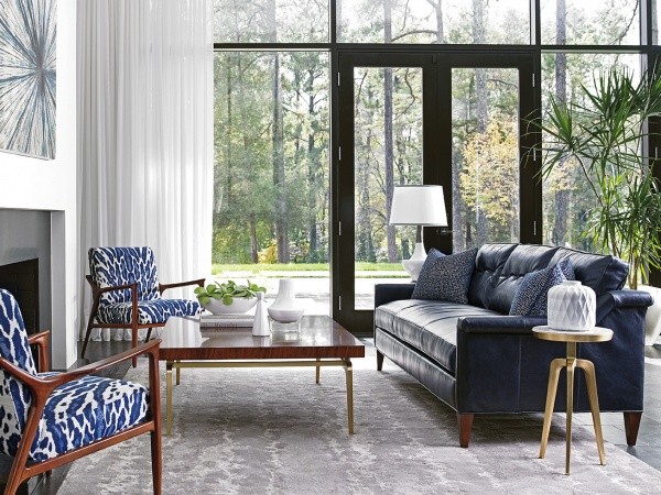 luxury living room featuring with blue and white color scheme with blue leather sofa and two blue and white animal print chairs