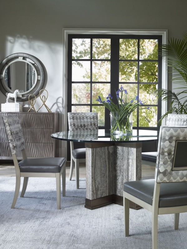 luxury dining room with round glass top table with four grey chairs